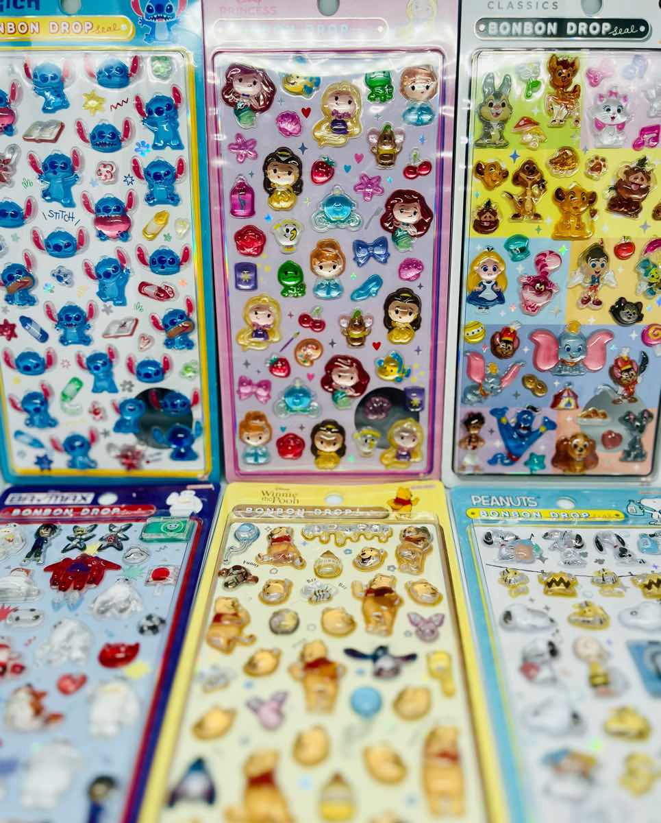 Flat lay of favorite Bonbon Drop stickers arranged on a pastel desk / パステルのデスクにお気に入りのボンボンドロップを並べたフラットレイ